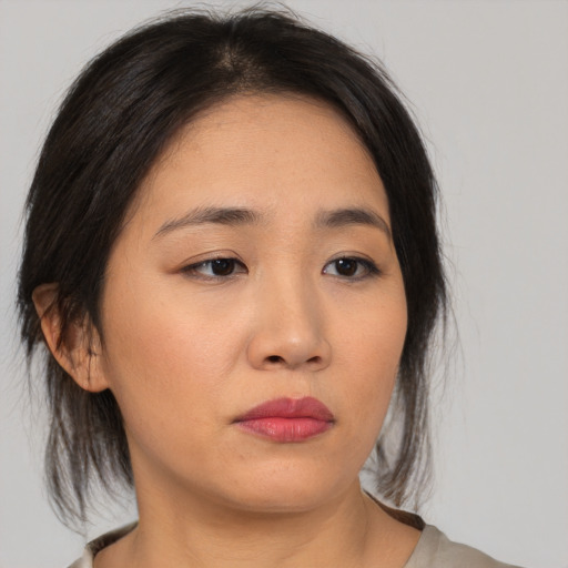Neutral asian young-adult female with medium  brown hair and brown eyes