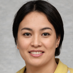 Joyful asian young-adult female with medium  brown hair and brown eyes