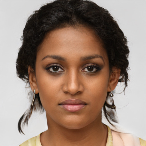 Joyful black young-adult female with medium  brown hair and brown eyes