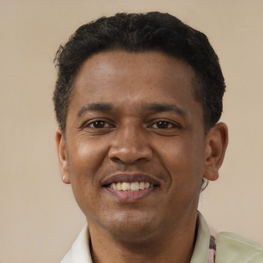 Joyful latino young-adult male with short  black hair and brown eyes