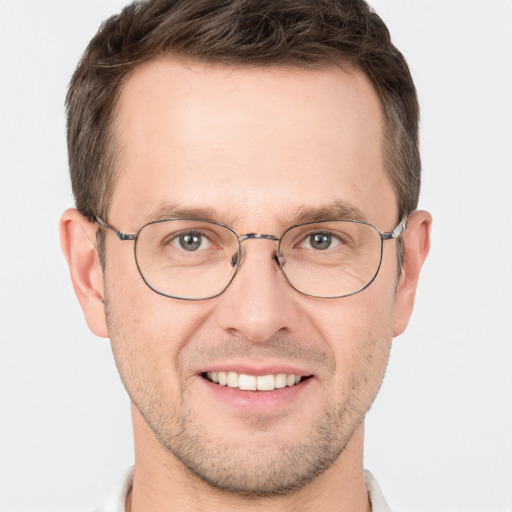 Joyful white adult male with short  brown hair and brown eyes