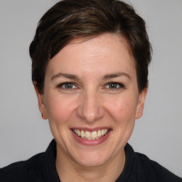 Joyful white adult female with medium  brown hair and grey eyes