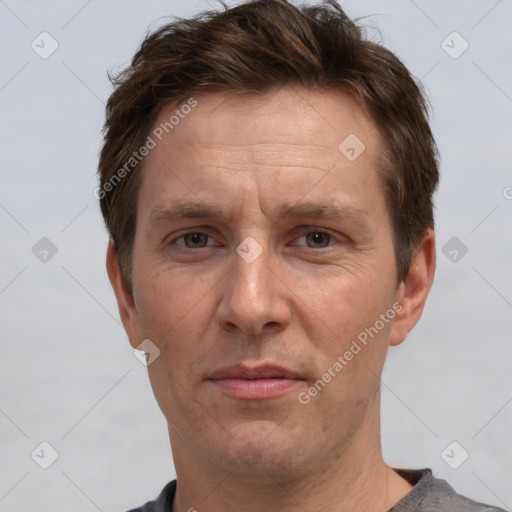 Joyful white adult male with short  brown hair and grey eyes