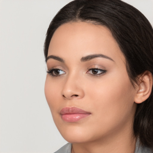 Joyful white young-adult female with medium  black hair and brown eyes