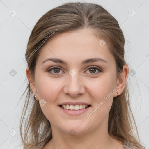 Joyful white young-adult female with medium  brown hair and grey eyes