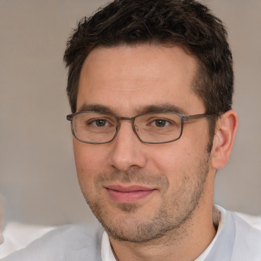 Joyful white adult male with short  brown hair and brown eyes