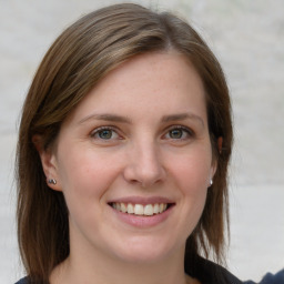 Joyful white young-adult female with medium  brown hair and grey eyes