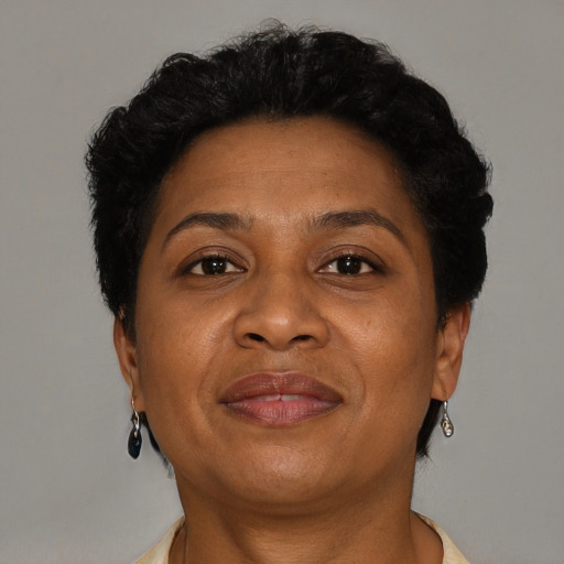 Joyful black adult female with short  brown hair and brown eyes