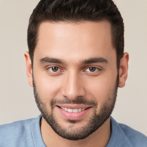 Joyful white young-adult male with short  brown hair and brown eyes