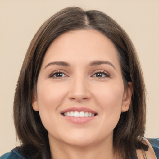 Joyful white young-adult female with medium  brown hair and brown eyes