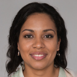 Joyful black young-adult female with medium  brown hair and brown eyes