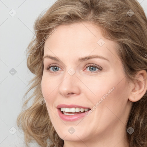 Joyful white young-adult female with medium  brown hair and blue eyes