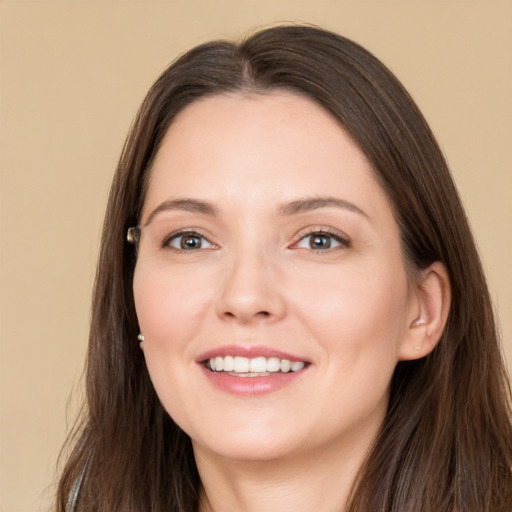 Joyful white young-adult female with long  brown hair and brown eyes