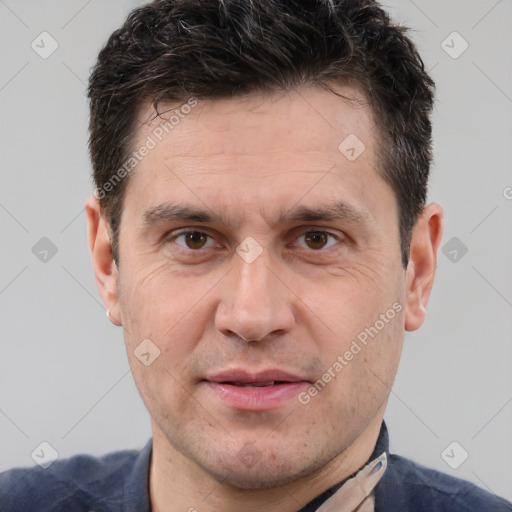 Joyful white adult male with short  brown hair and brown eyes