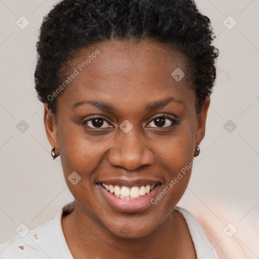 Joyful black young-adult female with short  brown hair and brown eyes