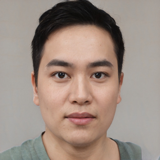 Joyful white young-adult male with short  black hair and brown eyes