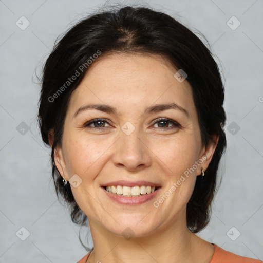 Joyful white adult female with medium  brown hair and brown eyes