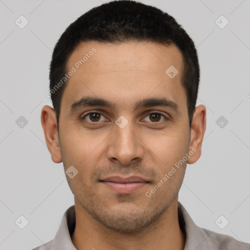 Joyful latino young-adult male with short  black hair and brown eyes