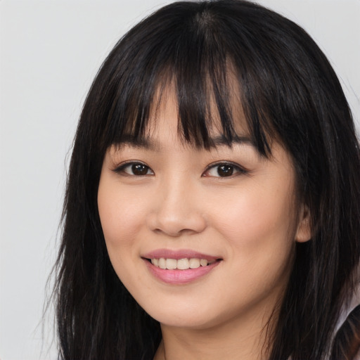 Joyful white young-adult female with long  black hair and brown eyes