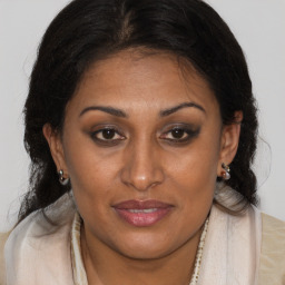 Joyful black adult female with medium  brown hair and brown eyes