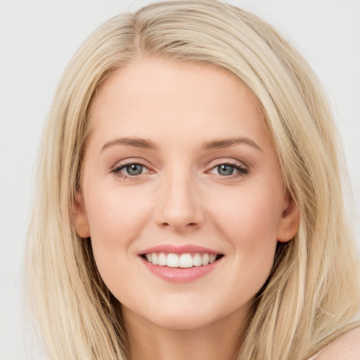 Joyful white young-adult female with long  brown hair and blue eyes