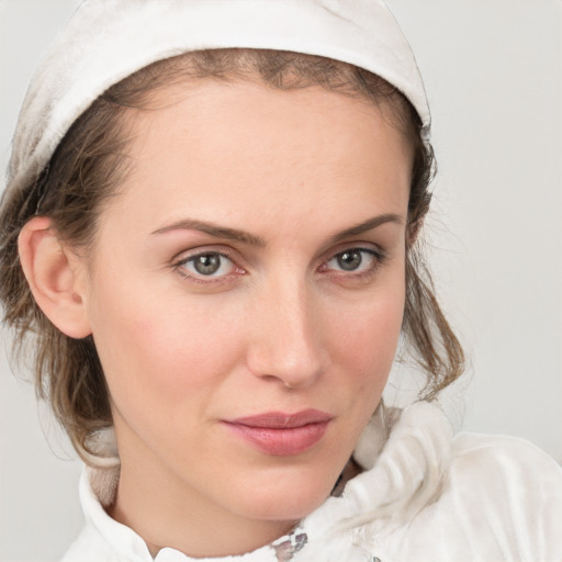 Joyful white young-adult female with medium  brown hair and blue eyes