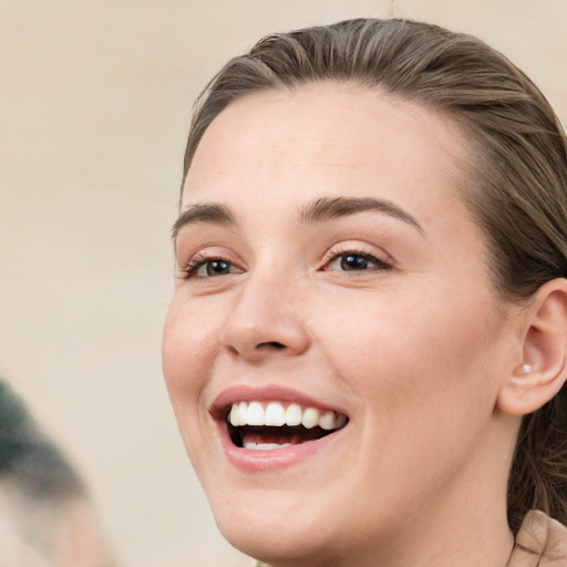 Joyful white young-adult female with medium  brown hair and blue eyes