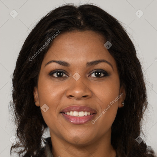 Joyful black young-adult female with long  brown hair and brown eyes