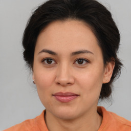 Joyful asian young-adult female with medium  brown hair and brown eyes