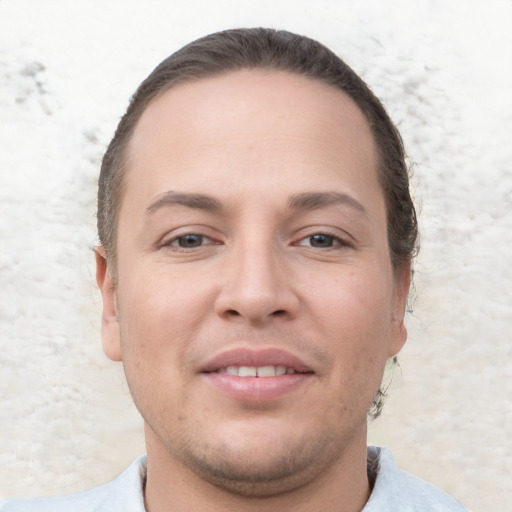 Joyful white young-adult male with short  brown hair and brown eyes