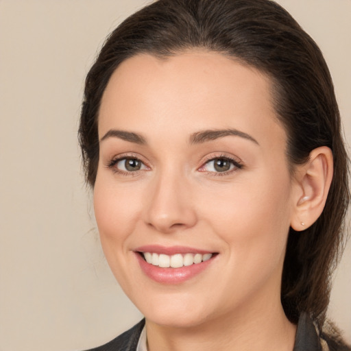 Joyful white young-adult female with medium  brown hair and brown eyes