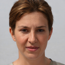 Joyful white adult female with short  brown hair and grey eyes