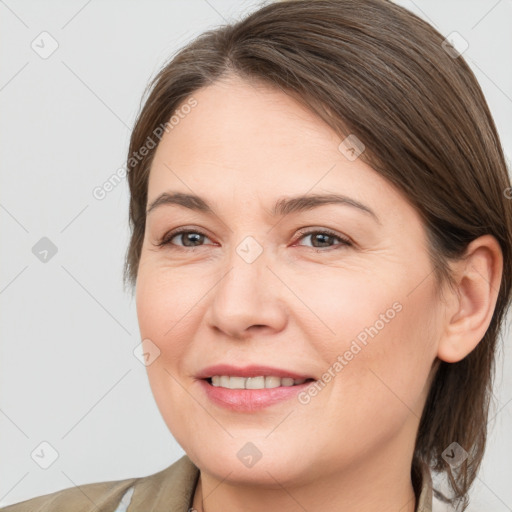 Joyful white adult female with medium  brown hair and grey eyes