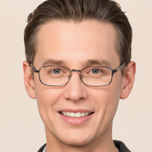 Joyful white adult male with short  brown hair and grey eyes