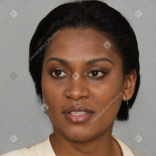 Joyful black young-adult female with short  black hair and brown eyes