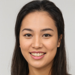 Joyful asian young-adult female with long  brown hair and brown eyes