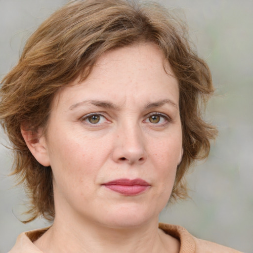 Joyful white adult female with medium  brown hair and grey eyes