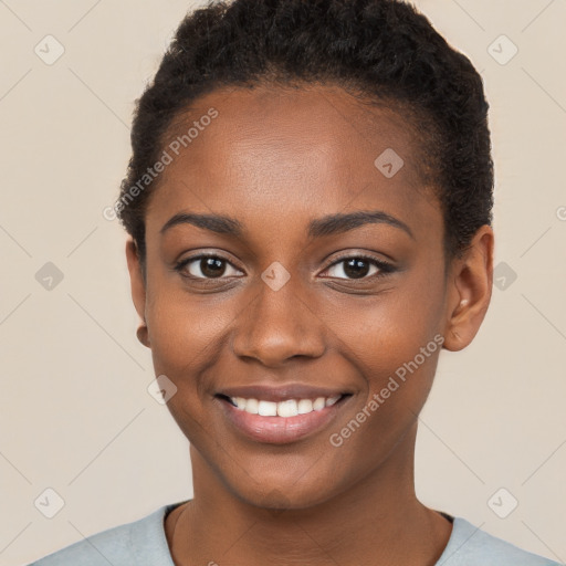 Joyful black young-adult female with short  brown hair and brown eyes