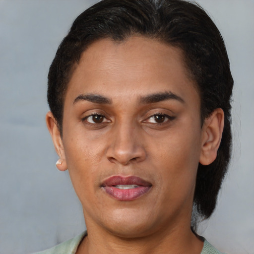Joyful latino young-adult female with short  brown hair and brown eyes