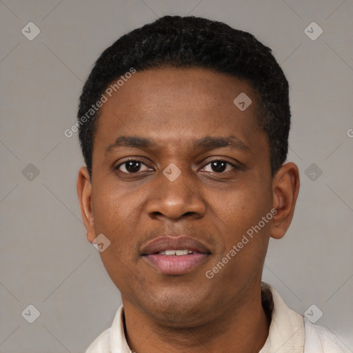 Joyful black young-adult male with short  black hair and brown eyes