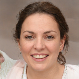 Joyful white young-adult female with medium  brown hair and blue eyes