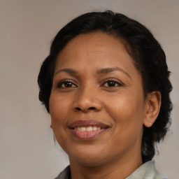 Joyful black young-adult female with medium  brown hair and brown eyes