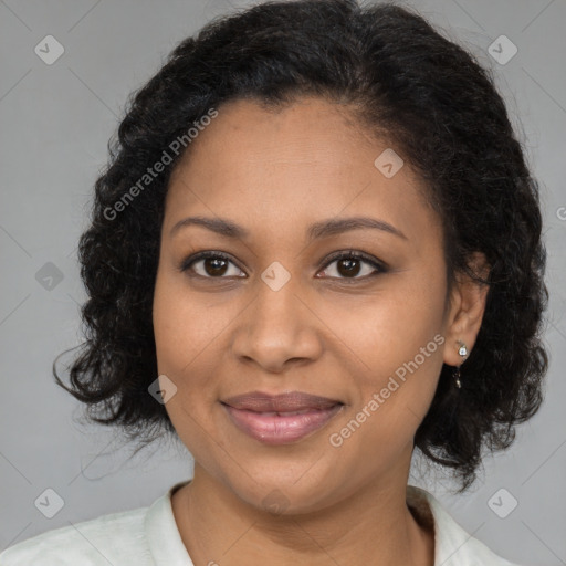 Joyful black adult female with medium  brown hair and brown eyes