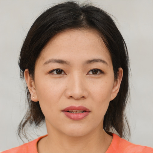 Joyful asian young-adult female with medium  brown hair and brown eyes