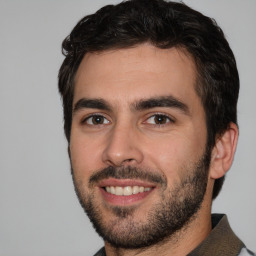 Joyful white young-adult male with short  black hair and brown eyes