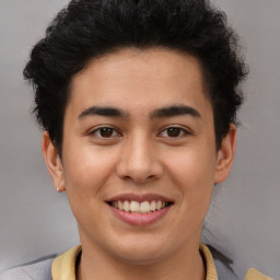 Joyful latino young-adult male with short  brown hair and brown eyes