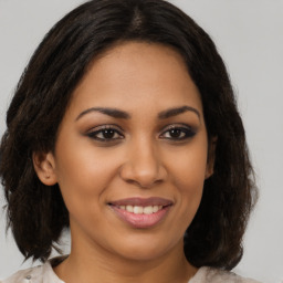 Joyful latino young-adult female with medium  brown hair and brown eyes