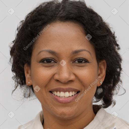 Joyful black adult female with medium  brown hair and brown eyes