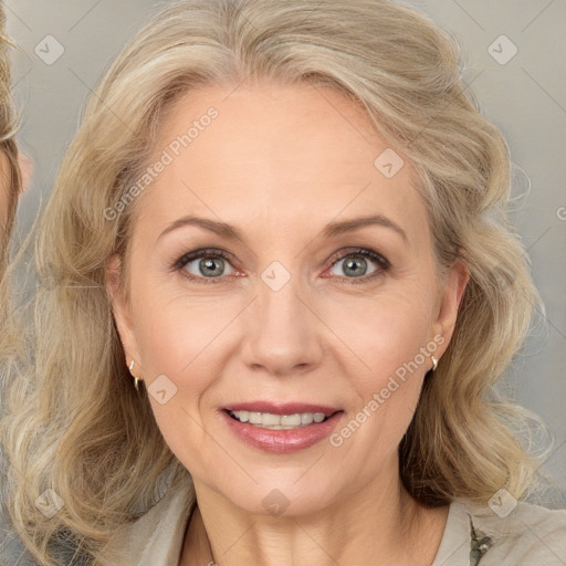 Joyful white adult female with medium  brown hair and blue eyes