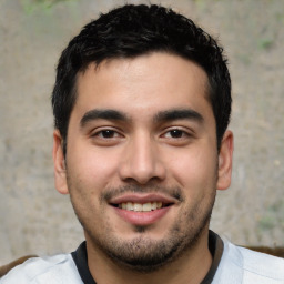 Joyful white young-adult male with short  black hair and brown eyes